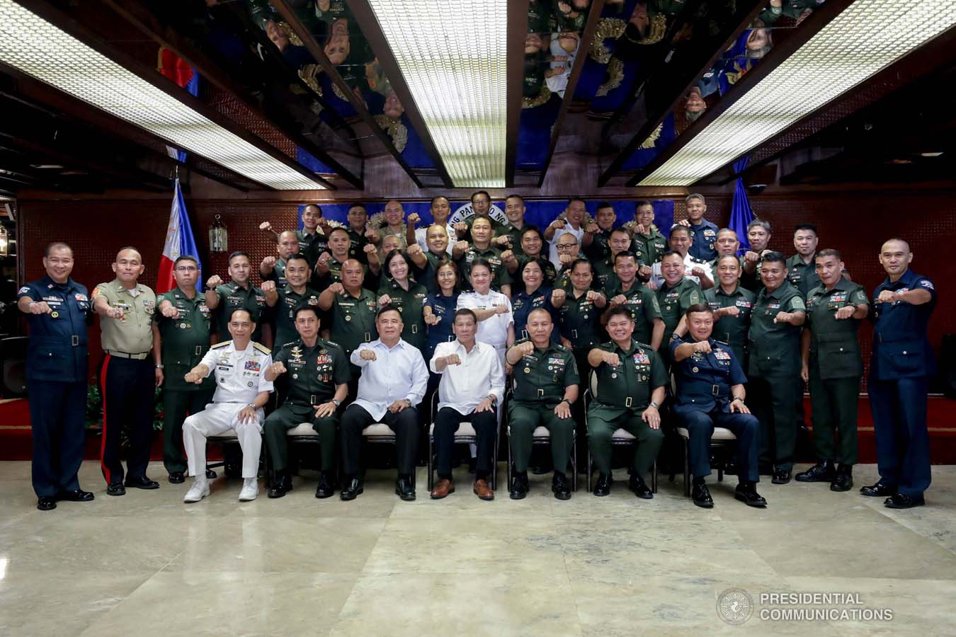 President Rodrigo Roa Duterte flashes his signature pose with officers of the Armed Forces of the Philippines Council of the Sergeants Major during the Thanksgiving gathering he hosted at the Malacañan Palace on December 10, 2019. SIMEON CELI JR./PRESIDENTIAL PHOTO