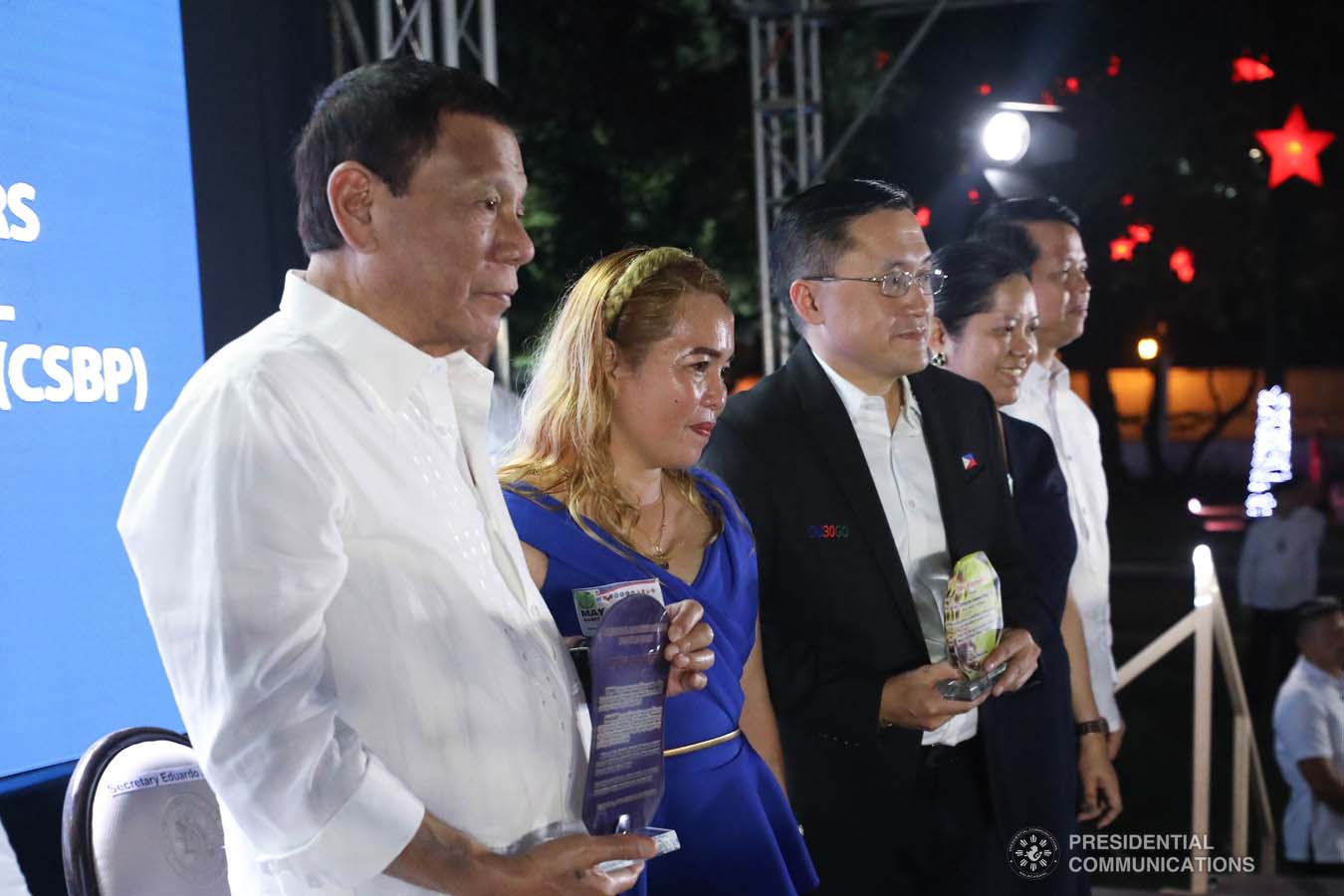 President Rodrigo Roa Duterte and Senator Christopher "Bong" Go pose for posterity as they receive plaques of appreciation from the beneficiaries of the killed-in-action (KIA) soldiers and killed-in-police operation (KIPO) personnel under the Comprehensive Social Benefits Program during the Thanksgiving party at the Malacañan Palace on December 10, 2019. SIMEON CELI JR./PRESIDENTIAL PHOTO