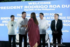 President Rodrigo Roa Duterte is greeted by one of the beneficiaries of the killed-in-action (KIA) soldiers and killed-in-police operation (KIPO) personnel under the Comprehensive Social Benefits Program during the Thanksgiving party at the Malacañan Palace on December 10, 2019. RICHARD MADELO/PRESIDENTIAL PHOTO