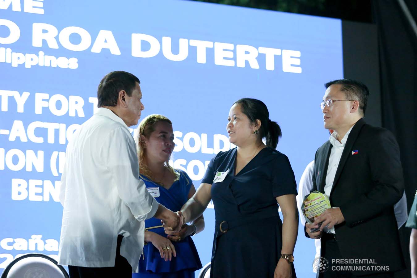 President Rodrigo Roa Duterte is greeted by one of the beneficiaries of the killed-in-action (KIA) soldiers and killed-in-police operation (KIPO) personnel under the Comprehensive Social Benefits Program during the Thanksgiving party at the Malacañan Palace on December 10, 2019. RICHARD MADELO/PRESIDENTIAL PHOTO