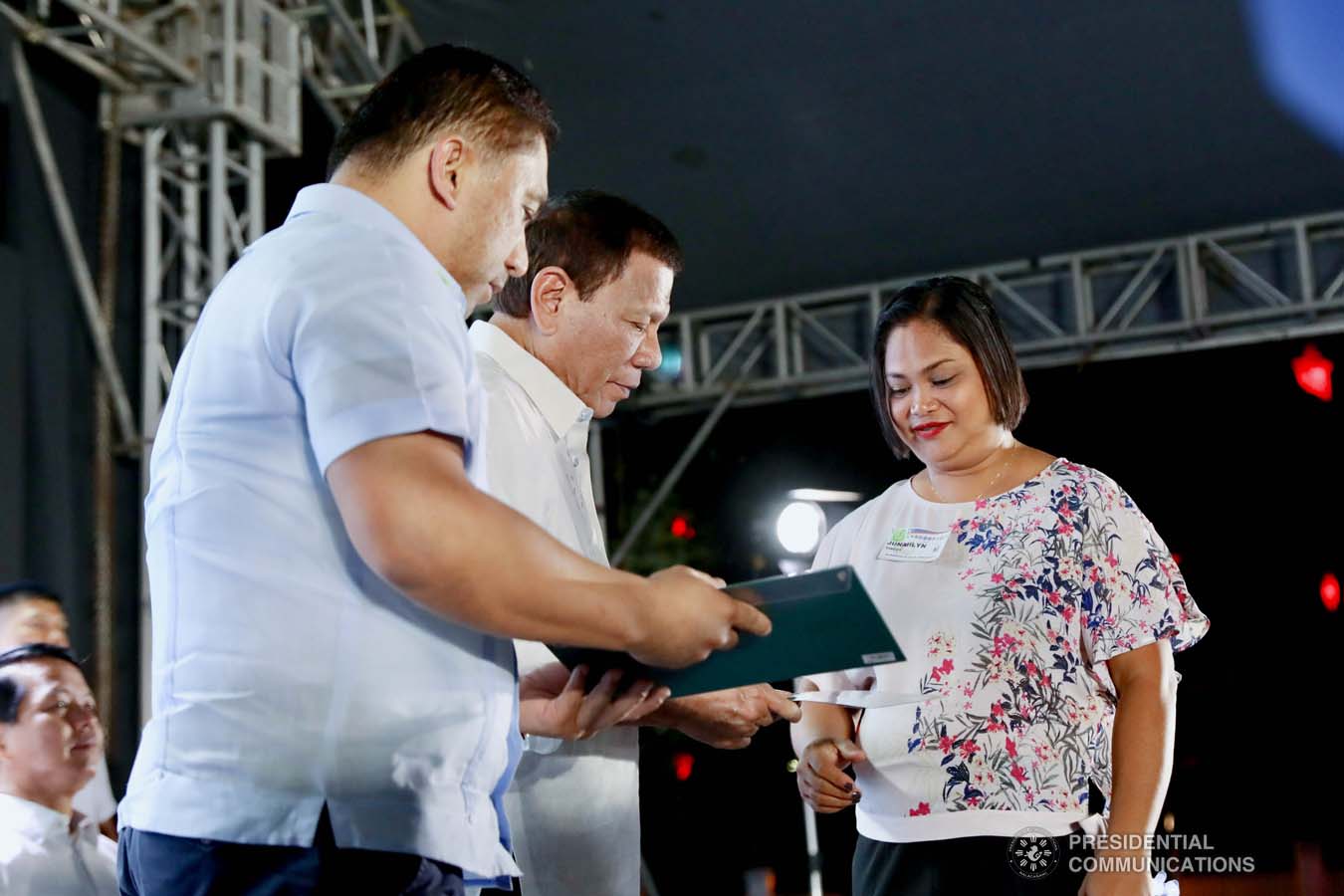 President Rodrigo Roa Duterte leads the ceremonial turnover of housing certificates and checks to the beneficiaries of the killed-in-action (KIA) soldiers and killed-in-police operation (KIPO) personnel under the Comprehensive Social Benefits Program during the Thanksgiving party at the Malacañan Palace on December 10, 2019. Assisting the President is National Housing Authority General Manager Marcelino Escalada Jr. RICHARD MADELO/PRESIDENTIAL PHOTO