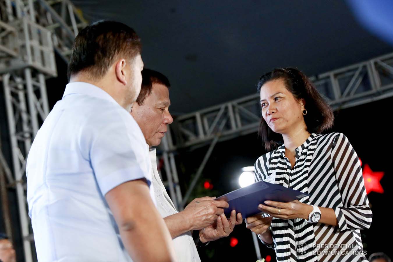 President Rodrigo Roa Duterte leads the ceremonial turnover of housing certificates and checks to the beneficiaries of the killed-in-action (KIA) soldiers and killed-in-police operation (KIPO) personnel under the Comprehensive Social Benefits Program during the Thanksgiving party at the Malacañan Palace on December 10, 2019. Assisting the President is National Housing Authority General Manager Marcelino Escalada Jr. RICHARD MADELO/PRESIDENTIAL PHOTO