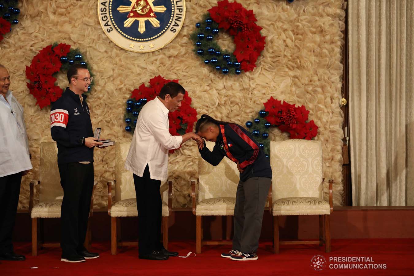 President Rodrigo Roa Duterte extends his hands to skateboarding gold medalist Margielyn Didal who showed a gesture of respect to the President during the awarding of the Order of Lapu-Lapu Rank of Kamagi to the 2019 Southeast Asian Games medalists at the Malacañan Palace on December 18, 2019. KARL NORMAN ALONZO/PRESIDENTIAL PHOTO