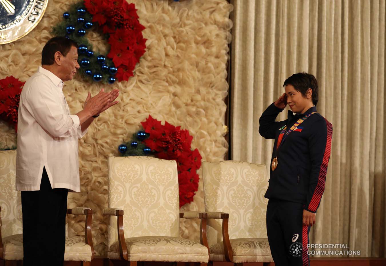 President Rodrigo Roa Duterte gets a salute from weightlifting gold medalist Hidilyn Diaz during the awarding of the Order of Lapu-Lapu Rank of Kamagi to the 2019 Southeast Asian Games medalists at the Malacañan Palace on December 18, 2019. KARL NORMAN ALONZO/PRESIDENTIAL PHOTO