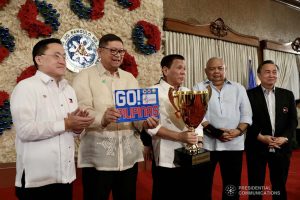 President Rodrigo Roa Duterte holds the overall champion trophy of the Philippine Team during the recognition of the 2019 Southeast Asian Games medalists at the Malacañan Palace on December 18, 2019. The Philippine Team emerged as overall champion in the recently-concluded 2019 SEA Games after garnering 149 golds, 117 silvers and 121 bronzes. With the President are Senator Christopher "Bong" Go, Philippine Sports Commission Chairman William Ramirez, Executive Secretary Salvador Medialdea and Philippine Olympic Committee President and Cavite Eighth District Representative Abraham Tolentino. RICHARD MADELO/PRESIDENTIAL PHOTO