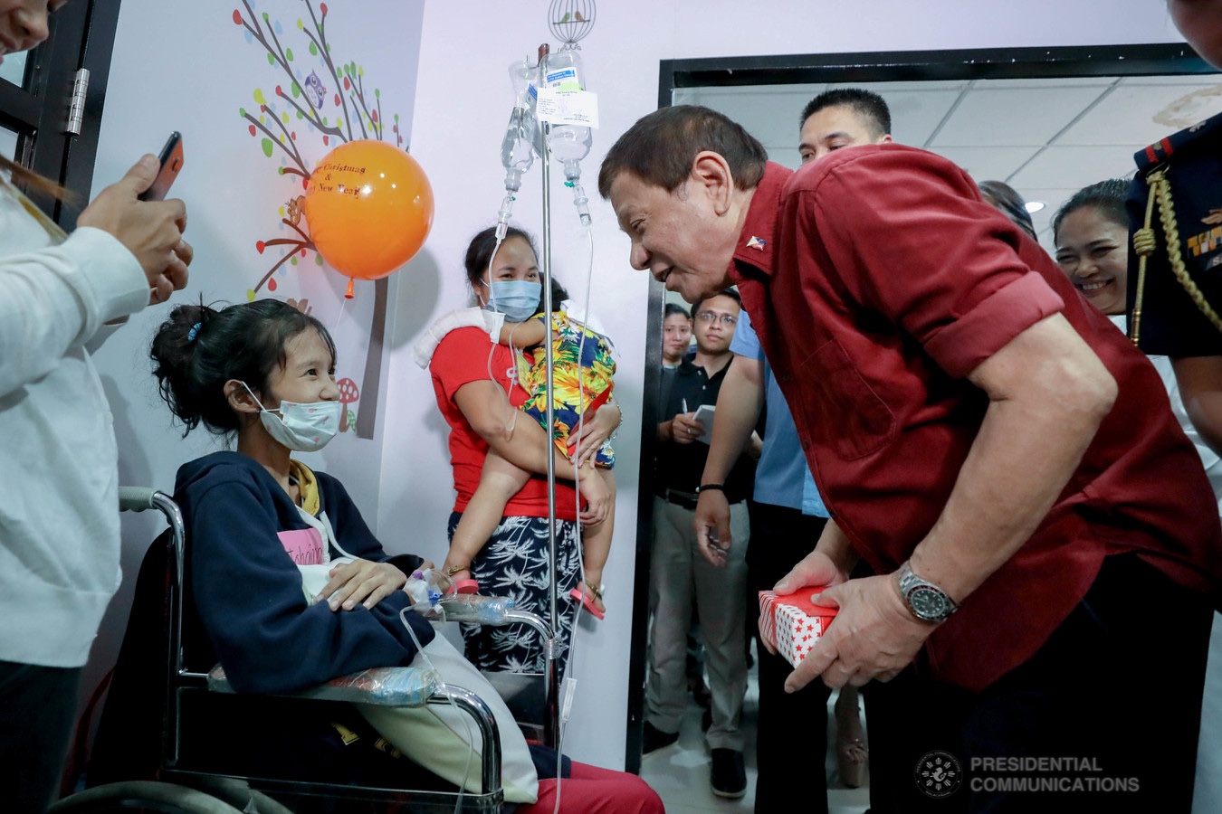 President Rodrigo Roa Duterte gives a Christmas present to one of the pediatric cancer patients he visited at the Southern Philippines Medical Center Children's Cancer Institute in Davao City on December 28, 2019. RICHARD MADELO/PRESIDENTIAL PHOTO