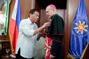President Rodrigo Roa Duterte confers the Order of Sikatuna with the Rank of Datu on outgoing Apostolic Nuncio of the Holy See to the Philippines Archbishop Gabriele Caccia during his farewell call to the President at the Malacañan Palace on December 11, 2019. ROBINSON NIÑAL JR./PRESIDENTIAL PHOTO