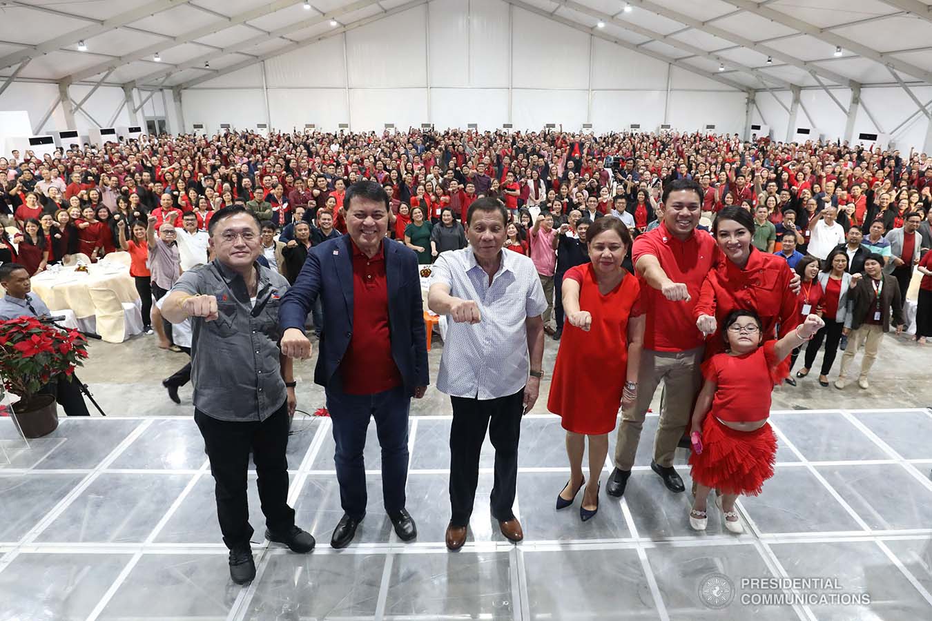 President Rodrigo Roa Duterte strikes his signature pose with Senator Christopher "Bong" Go, former Senate President Manuel Villar, Senator Cynthia Villar and Public Works and Highways Secretary Mark Villar during the inauguration of The Tent at Vista Global South in Las Piñas City on December 12, 2019. SIMEON CELI JR./PRESIDENTIAL PHOTO