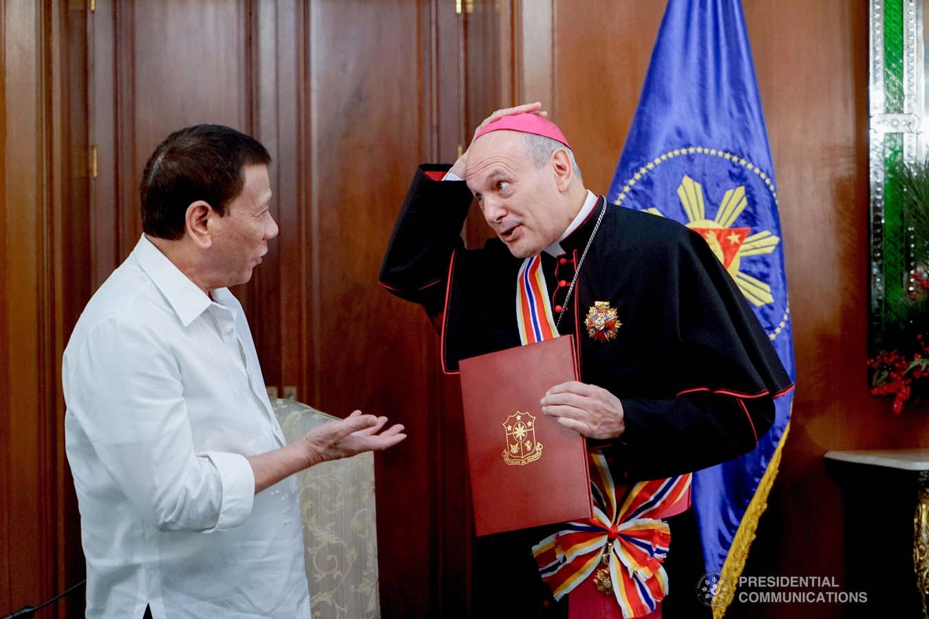 President Rodrigo Roa Duterte confers the Order of Sikatuna with the Rank of Datu on outgoing Apostolic Nuncio of the Holy See to the Philippines Archbishop Gabriele Caccia during his farewell call to the President at the Malacañan Palace on December 11, 2019. KING RODRIGUEZ/PRESIDENTIAL PHOTO