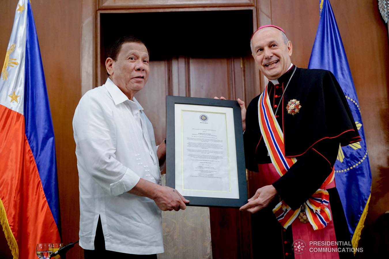 President Rodrigo Roa Duterte confers the Order of Sikatuna with the Rank of Datu on outgoing Apostolic Nuncio of the Holy See to the Philippines Archbishop Gabriele Caccia during his farewell call to the President at the Malacañan Palace on December 11, 2019. KING RODRIGUEZ/PRESIDENTIAL PHOTO