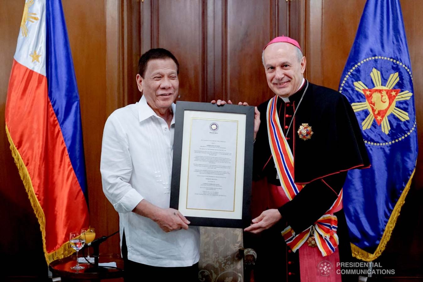 President Rodrigo Roa Duterte confers the Order of Sikatuna with the Rank of Datu on outgoing Apostolic Nuncio of the Holy See to the Philippines Archbishop Gabriele Caccia during his farewell call to the President at the Malacañan Palace on December 11, 2019. KING RODRIGUEZ/PRESIDENTIAL PHOTO