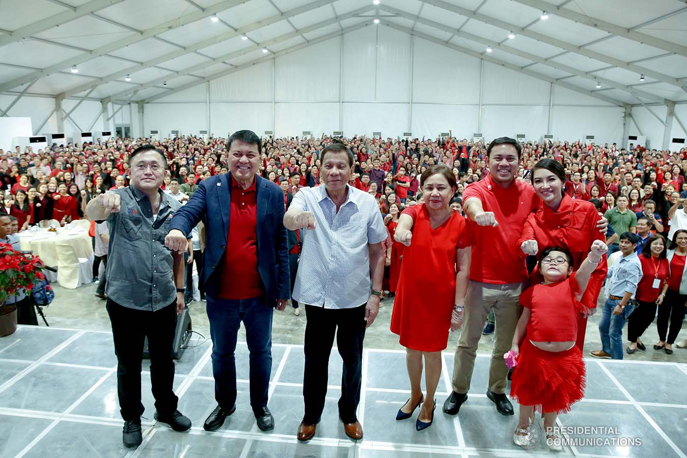 President Rodrigo Roa Duterte strikes his signature pose with Senator Christopher "Bong" Go, former Senate President Manuel Villar, Senator Cynthia Villar and Public Works and Highways Secretary Mark Villar during the inauguration of The Tent at Vista Global South in Las Piñas City on December 12, 2019. RICHARD MADELO/PRESIDENTIAL PHOTO