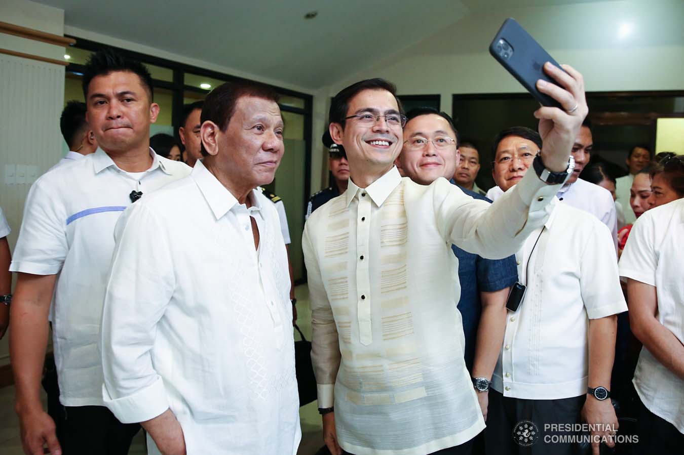 President Rodrigo Roa Duterte poses for a selfie with  Manila City Mayor Francisco Domagoso, Senator Christopher "Bong" Go and Interior and Local Government Secretary Eduardo Año during the closing ceremony of the National Reserve Officers' Training Corps (ROTC) Summit and the 1st Presidential Silent Drill Competition at the Quirino Grandstand in Manila on December 20, 2019. REY BANIQUET/PRESIDENTIAL PHOTO