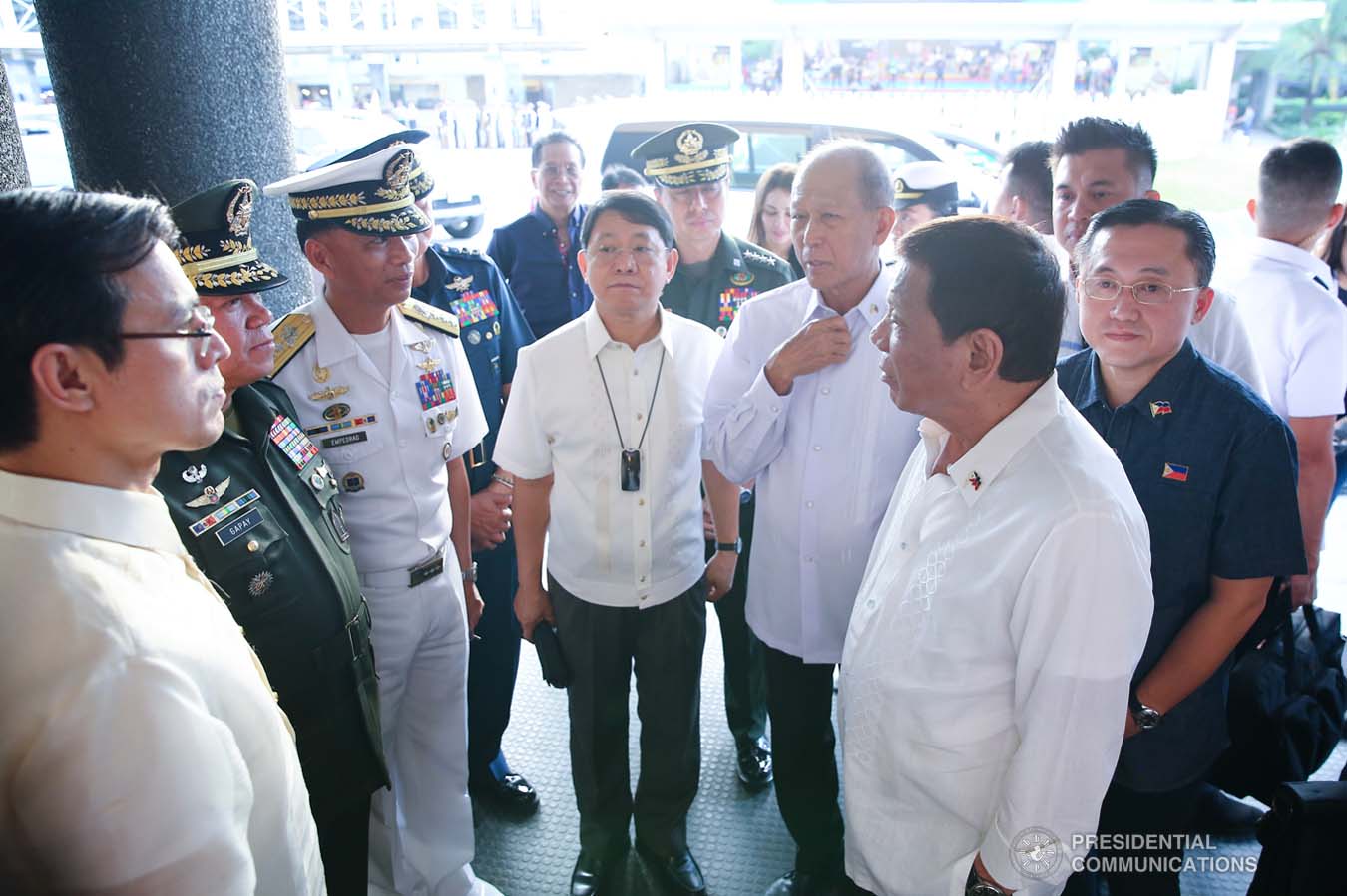 President Rodrigo Roa Duterte chats with Manila City Mayor Francisco Domagoso, Interior and Local Government Secretary Eduardo Año, Defense Secretary Delfin Lorenzana, Senator Christopher "Bong" Go and military and police officers during the closing ceremony of the National Reserve Officers' Training Corps (ROTC) Summit and the 1st Presidential Silent Drill Competition at the Quirino Grandstand in Manila on December 20, 2019. REY BANIQUET/PRESIDENTIAL PHOTO