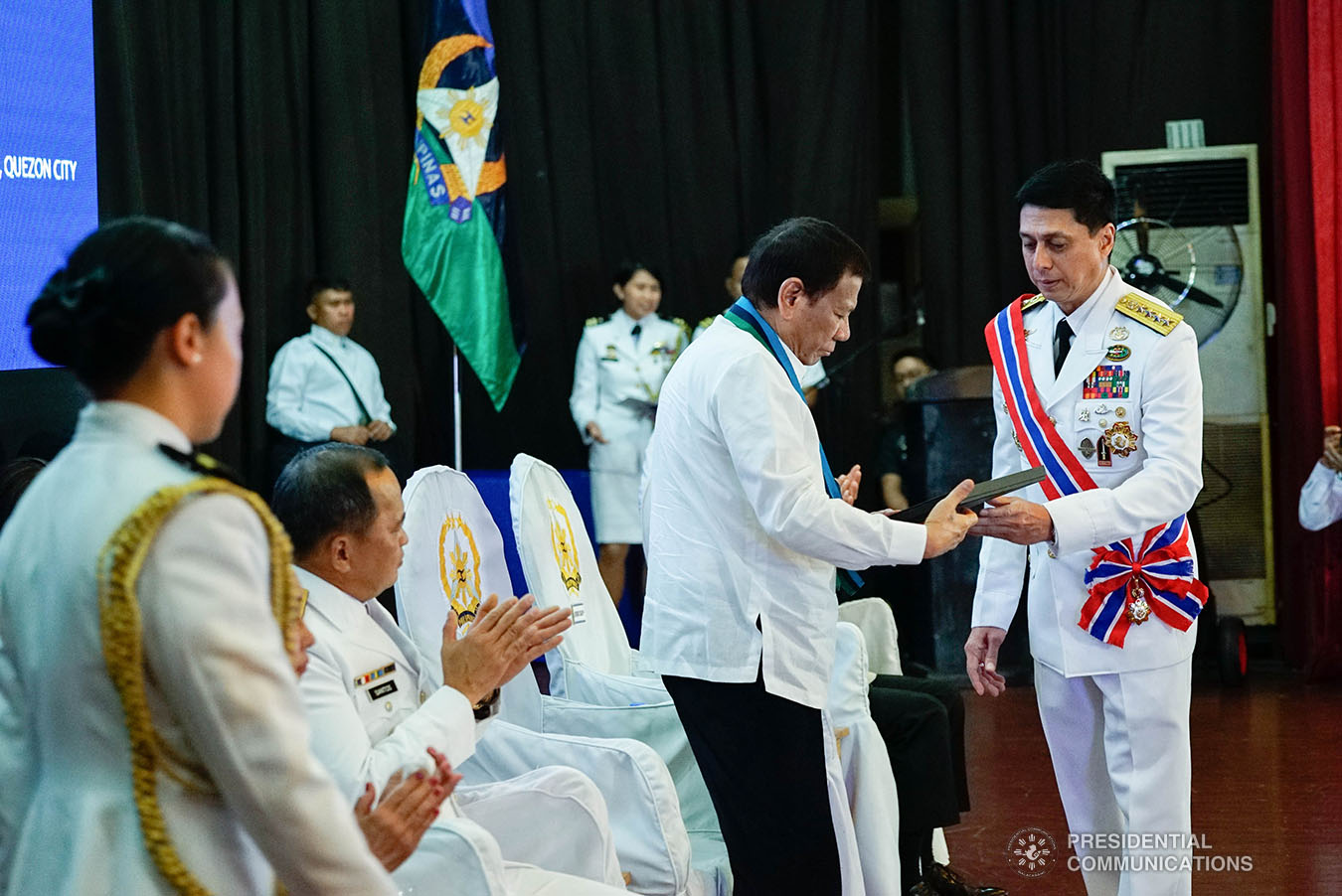 President Rodrigo Roa Duterte receives a book from outgoing Armed Forces of the Philippines (AFP) Chief of Staff General Noel Clement during the AFP Change of Command ceremony at Camp General Emilio Aguinaldo in Quezon City on January 4, 2020. KING RODRIGUEZ/PRESIDENTIAL PHOTO