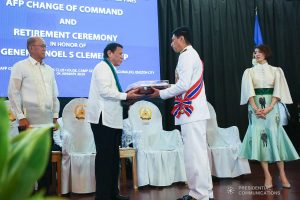 President Rodrigo Roa Duterte presents an encased Philippine Flag to outgoing Armed Forces of the Philippines (AFP) Chief of Staff General Noel Clement during the AFP Change of Command ceremony at Camp General Emilio Aguinaldo in Quezon City on January 4, 2020. REY BANIQUET/PRESIDENTIAL PHOTO