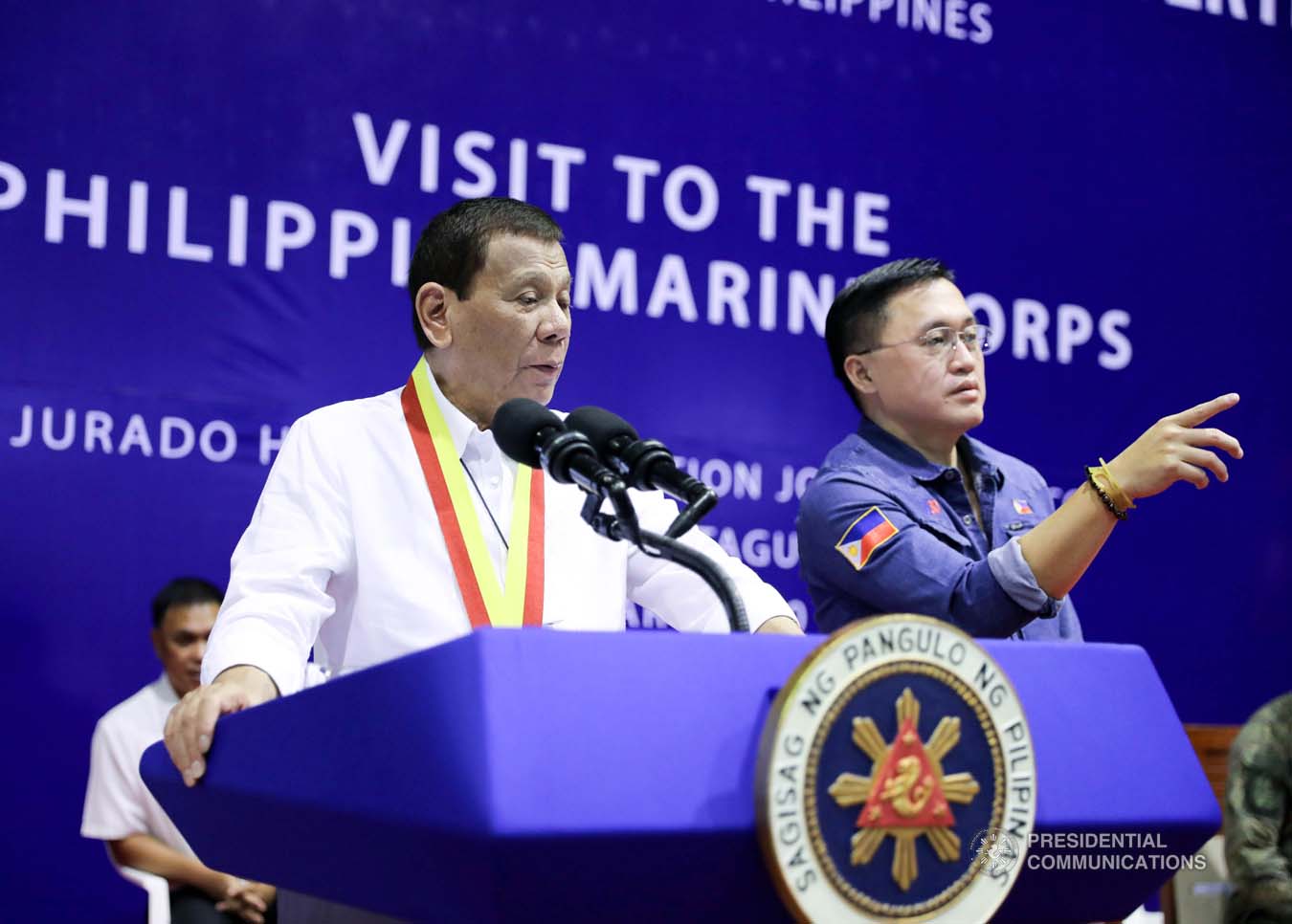 President Rodrigo Roa Duterte confers with Senator Christopher "Bong" Go while delivering a speech during his visit to the Philippine Marine Corps headquarters at Fort Bonifacio in Taguig City on January 13, 2020. ALFRED FRIAS/PRESIDENTIAL PHOTO