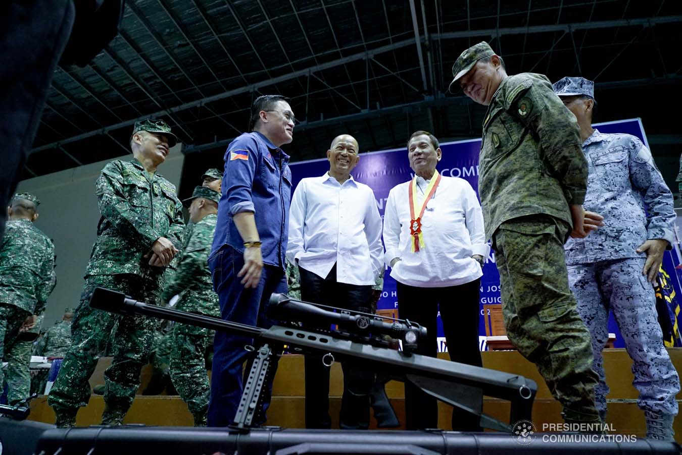President Rodrigo Roa Duterte shares a light moment with Senator Christopher "Bong" Go and Defense Secretary Delfin Lorenzana after leading the ceremonial distribution of firearms to the personnel of the Philippine Marine Corps at Fort Bonifacio in Taguig City on January 13, 2020. KING RODRIGUEZ/PRESIDENTIAL PHOTO