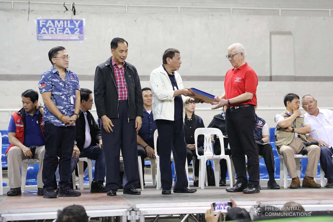 President Rodrigo Roa Duterte hands over the livelihood assistance for the farmers and fisherfolks affected by the Taal Volcano eruption to Batangas Governor Hermilando Mandanas during his visit at the Batangas City Sports Coliseum on January 14, 2020. VALERIE ESCALERA/PRESIDENTIAL PHOTO