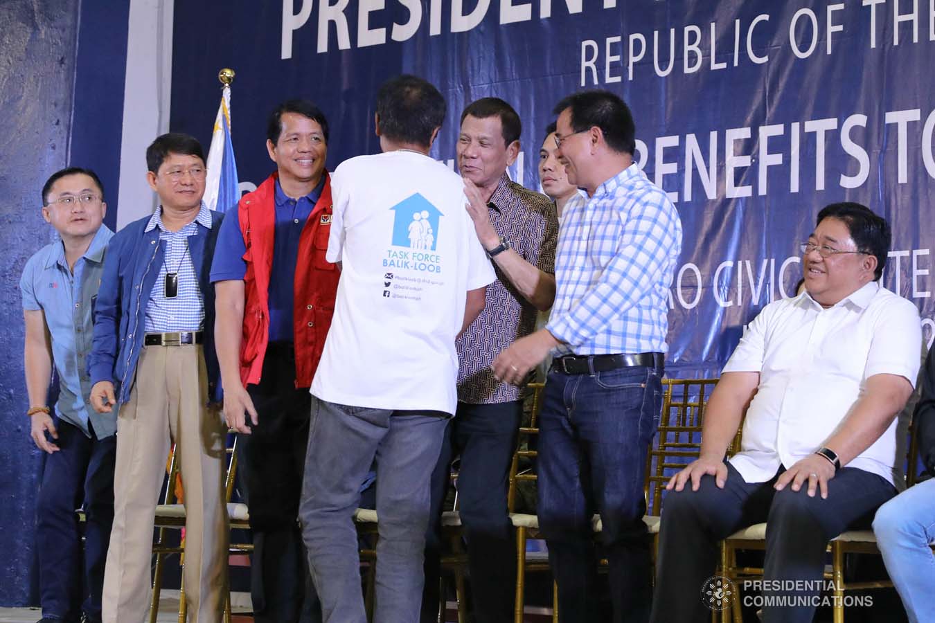 President Rodrigo Roa Duterte shares a light moment with a former rebel as he leads the distribution of their benefits during a ceremony at the San Isidro Central School in Leyte on January 23, 2020. VALERIE ESCALERA/PRESIDENTIAL PHOTO