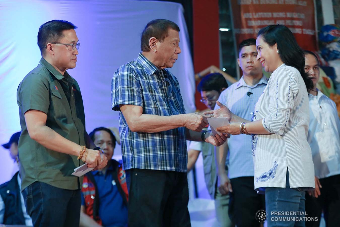 President Rodrigo Roa Duterte hands the over cash assistance to Tanauan City residents, who are affected by the Taal Volcano eruption, at the Polytechnic University of the Philippines-Sto. Tomas Campus in Sto. Tomas City, Batangas on January 20, 2020. Receiving the assistance is Tanauan City Mayor Mary Angeline Halili. ACE MORANDANTE/PRESIDENTIAL PHOTO