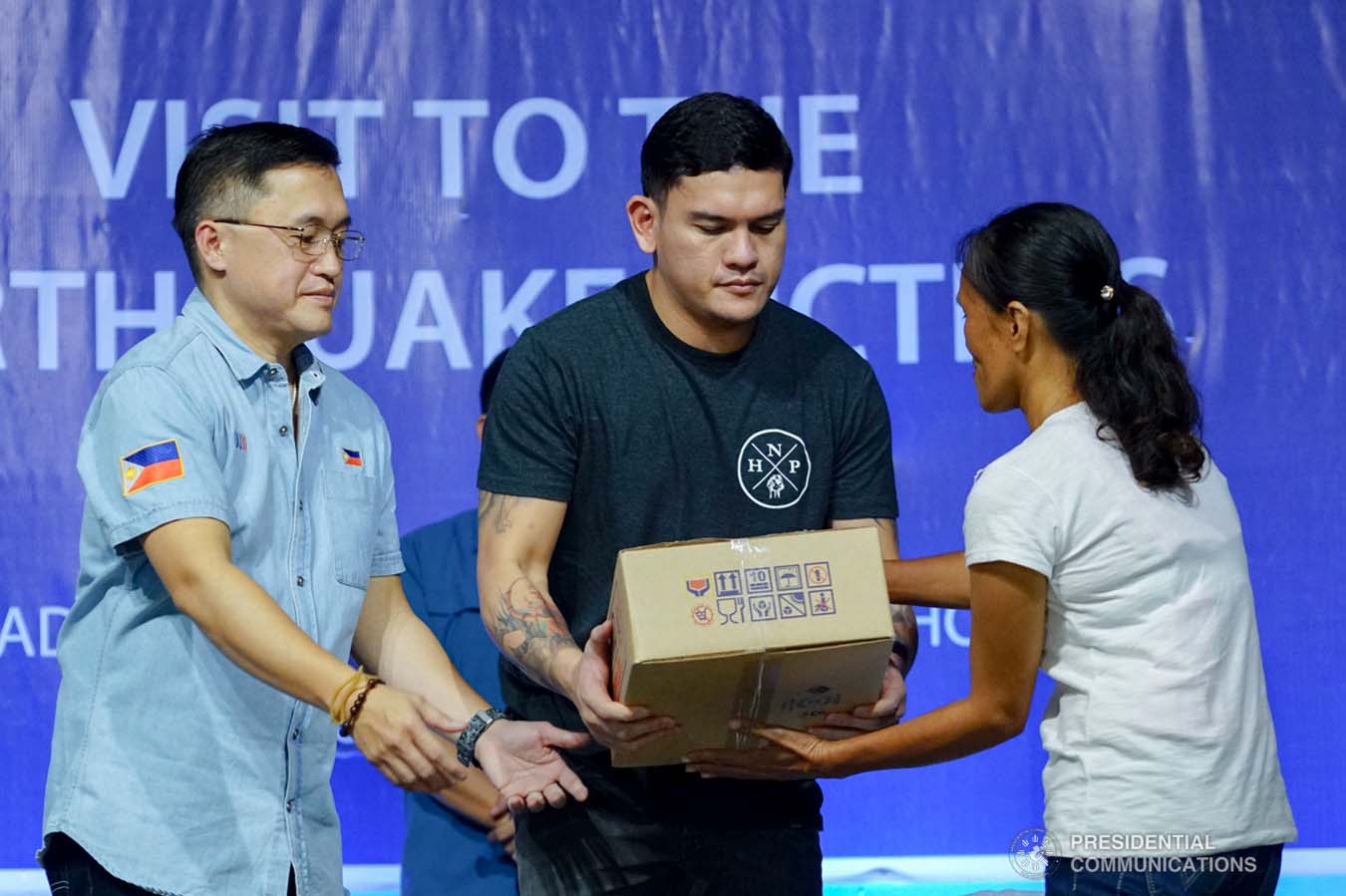 Davao City Vice Mayor Sebastian Duterte, who visited earthquake victims in Padada, Davao del Sur on behalf of his father President Rodrigo Roa Duterte, leads the ceremonial distribution of family food packs at the Padada Central Elementary School on January 3, 2020. Assisting the President's son is Senator Christopher "Bong" Go. JOEY DALUMPINES/PRESIDENTIAL PHOTO
