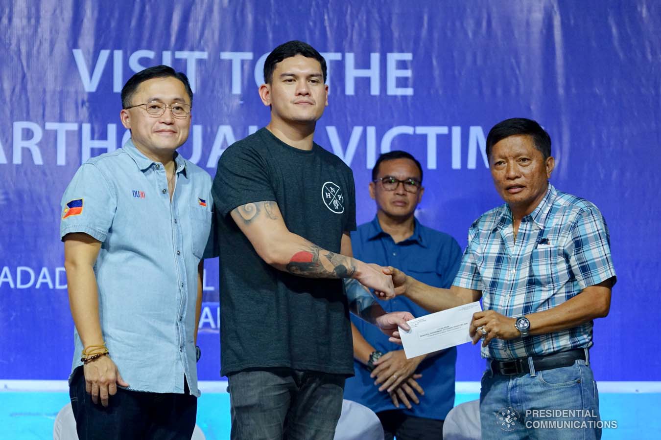 Davao City Vice Mayor Sebastian Duterte, who visited earthquake victims in Padada, Davao del Sur on behalf of his father President Rodrigo Roa Duterte, leads the ceremonial distribution of family food packs at the Padada Central Elementary School on January 3, 2020. Assisting the President's son is Senator Christopher "Bong" Go. RICHARD MADELO/PRESIDENTIAL PHOTO