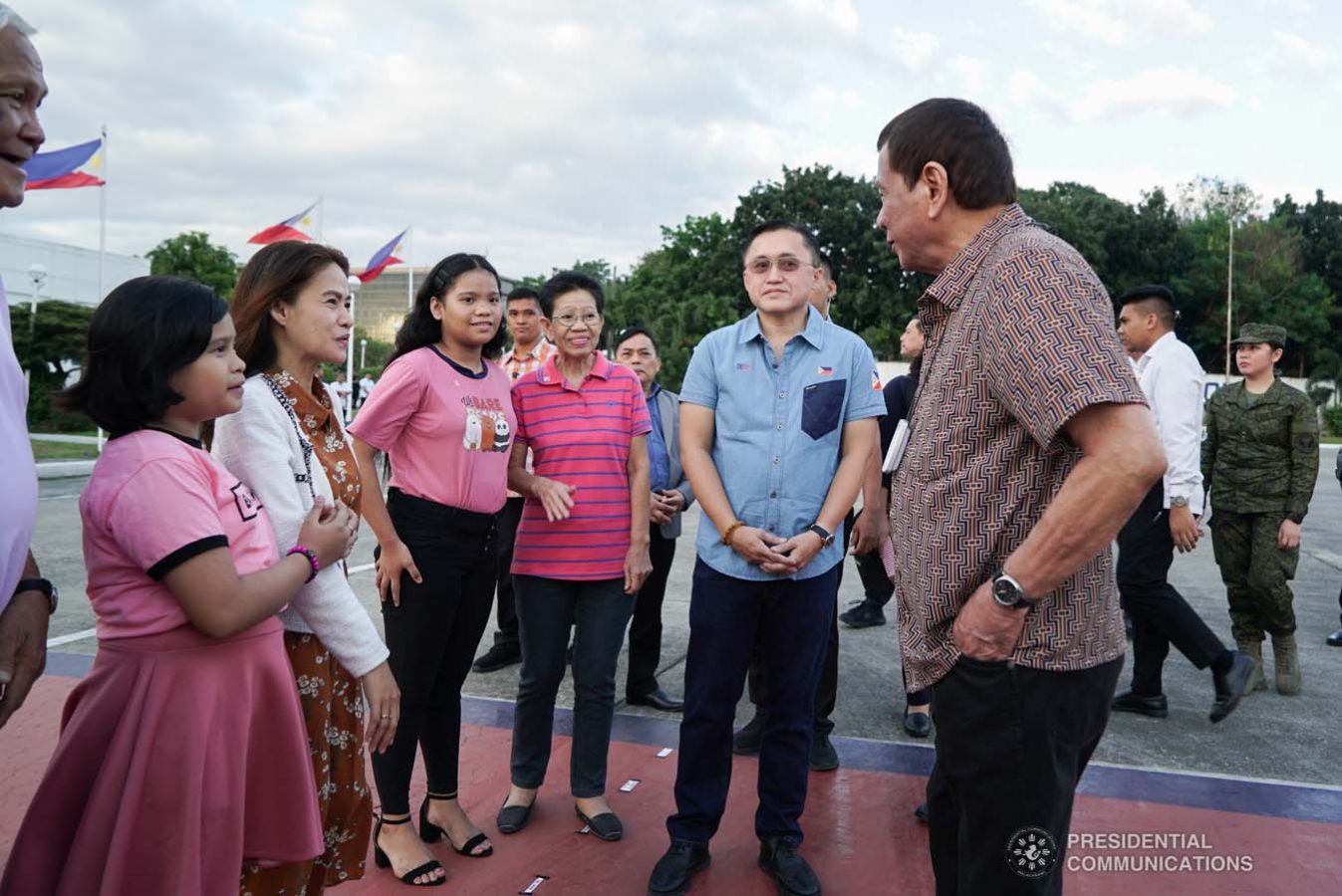 President Rodrigo Roa Duterte meets with the family of Overseas Filipino Worker (OFW) Roderick Aguinaldo, who is currently imprisoned in Bahrain, during the send-off at the Villamor Air Base in Pasay City on January 23, 2020. The family is set to visit the detained OFW on Saturday. With the President is Senator Christopher "Bong" Go. KING RODRIGUEZ/PRESIDENTIAL PHOTO
