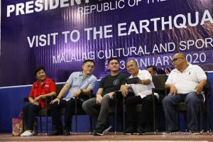 Davao City Vice Mayor Sebastian Duterte, who visited earthquake victims in Malalag, Davao del Sur on behalf of his father President Rodrigo Roa Duterte, poses for a selfie with Malalag Mayor Peter Valentin at the Malalag Cultural and Sports Center on January 3, 2020. Also in photo is Senator Christopher "Bong" Go. KARL NORMAN ALONZO/PRESIDENTIAL PHOTO