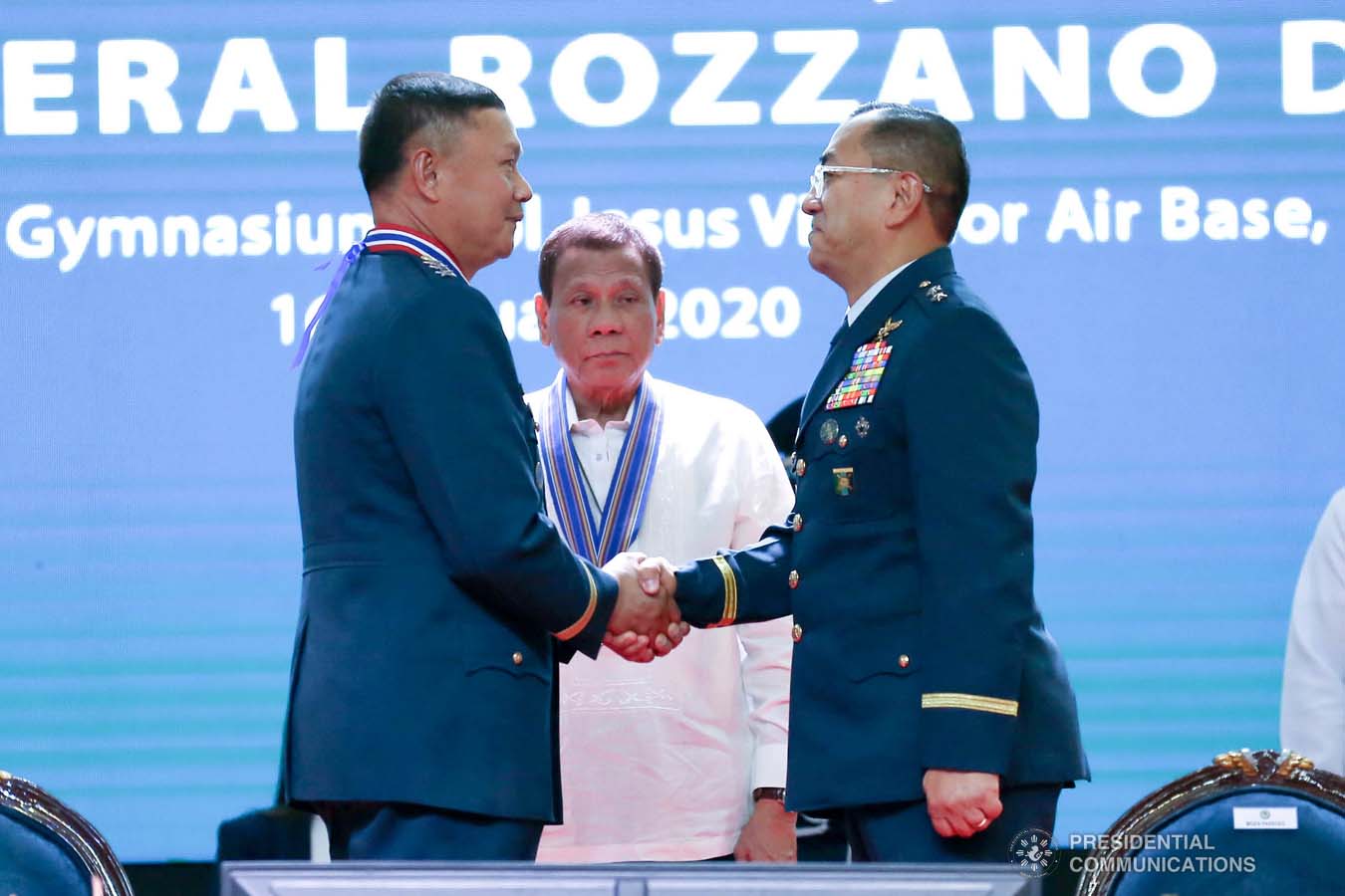President Rodrigo Roa Duterte looks on as outgoing Philippine Air Force (PAF) Commanding General Lieutenant General Rozzano Briguez and incoming PAF Commanding General Major General Allen Paredes shake hands during the PAF Change of Command ceremony at the Col. Jesus Villamor Air Base in Pasay City on January 16, 2020. KARL NORMAN ALONZO/PRESIDENTIAL PHOTO
