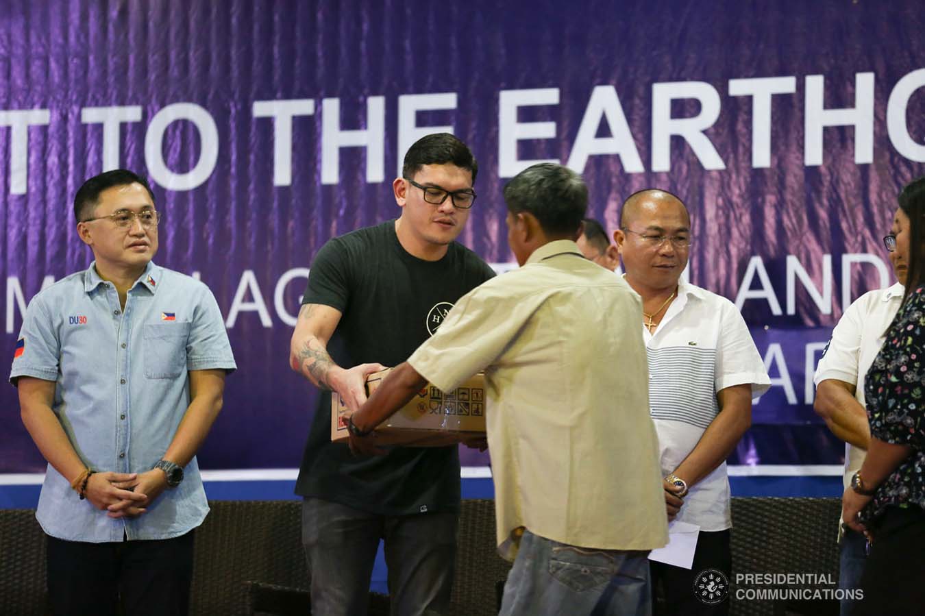 Davao City Vice Mayor Sebastian Duterte, who visited earthquake victims in Malalag, Davao del Sur on behalf of his father President Rodrigo Roa Duterte, leads the ceremonial distribution of family food packs at the Malalag Cultural and Sports Center on January 3, 2020. Assisting the President's son is Senator Christopher "Bong" Go. KARL NORMAN ALONZO/PRESIDENTIAL PHOTO