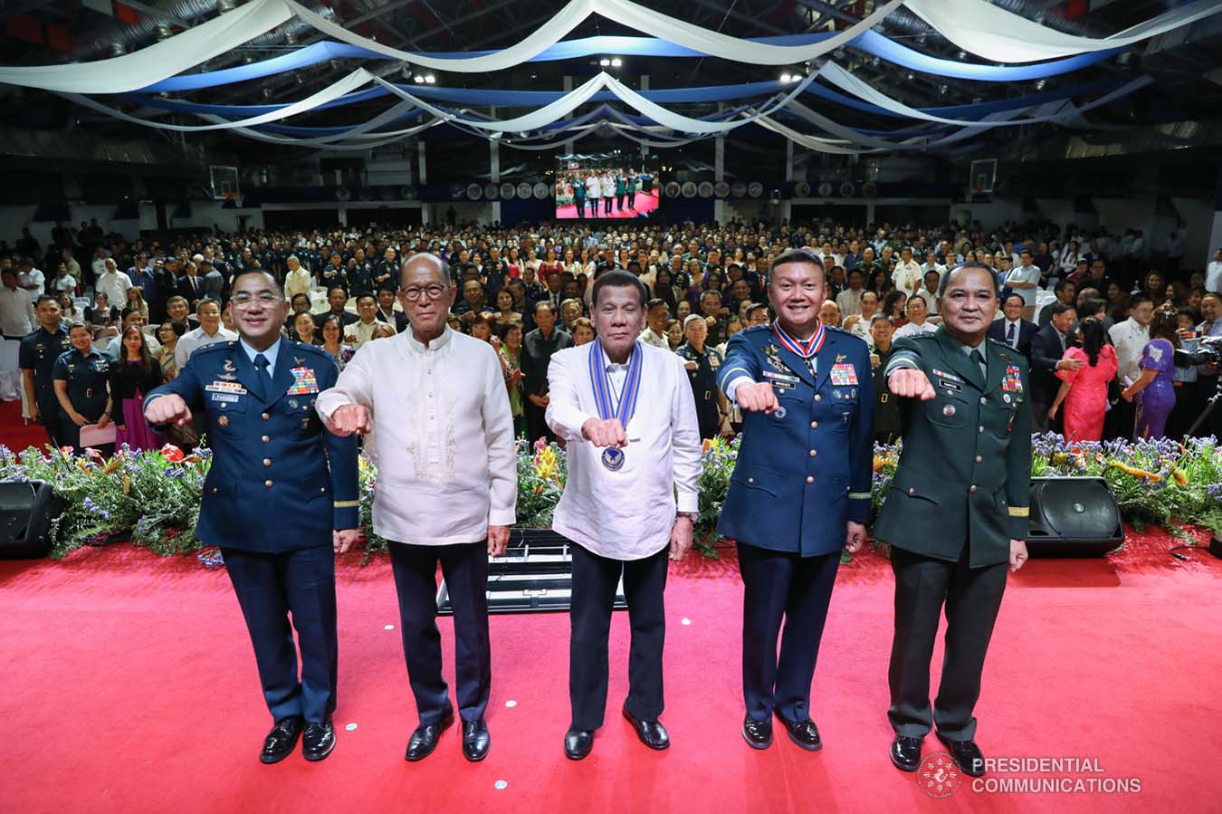President Rodrigo Roa Duterte flashes his signature pose with incoming Philippine Air Force (PAF) Commanding General Major General Allen Paredes, Defense Secretary Delfin Lorenzana, outgoing PAF Commanding General Lieutenant General Rozzano Briguez and Armed Forces of the Philippines Chief of Staff Lieutenant General Felimon Santos Jr. during the PAF Change of Command ceremony at the Col. Jesus Villamor Air Base in Pasay City on January 16, 2020. KARL NORMAN ALONZO/PRESIDENTIAL PHOTO