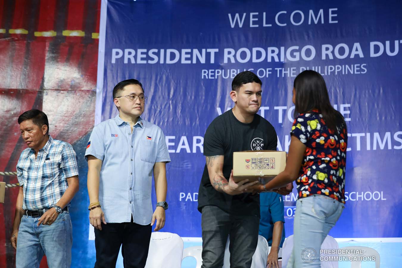 Davao City Vice Mayor Sebastian Duterte, who visited the earthquake victims in Padada, Davao del Sur on behalf of his father President Rodrigo Roa Duterte, leads the ceremonial distribution of family food packs at the Padada Central Elementary School on January 3, 2020. Assisting the President's son is Senator Christopher "Bong" Go. RICHARD MADELO/PRESIDENTIAL PHOTO