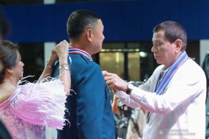President Rodrigo Roa Duterte confers the Philippine Legion of Honor with the degree of Commander on outgoing Philippine Air Force (PAF) Commanding General Lieutenant General Rozzano Briguez during the PAF Change of Command ceremony at the Col. Jesus Villamor Air Base in Pasay City on January 16, 2020. REY BANIQUET/PRESIDENTIAL PHOTO