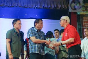 President Rodrigo Roa Duterte hands over the calamity assistance for the Provincial Government of Batangas to Batangas Governor Hermilando Mandanas during his visit to the families affected by the Taal Volcano eruption at the Polytechnic University of the Philippines-Sto. Tomas Campus in Sto. Tomas City, Batangas on January 20, 2020. With the President is Senator Christopher "Bong" Go. VALERIE ESCALERA/PRESIDENTIAL PHOTO