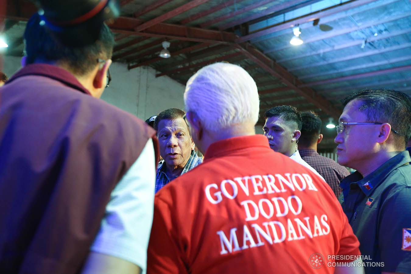 President Rodrigo Roa Duterte discusses matters with local government officials of Batangas after leading the ceremonial distribution of assistance to the families affected by the Taal Volcano eruption at the Polytechnic University of the Philippines-Sto. Tomas Campus in Sto. Tomas City, Batangas on January 20, 2020. VALERIE ESCALERA/PRESIDENTIAL PHOTO