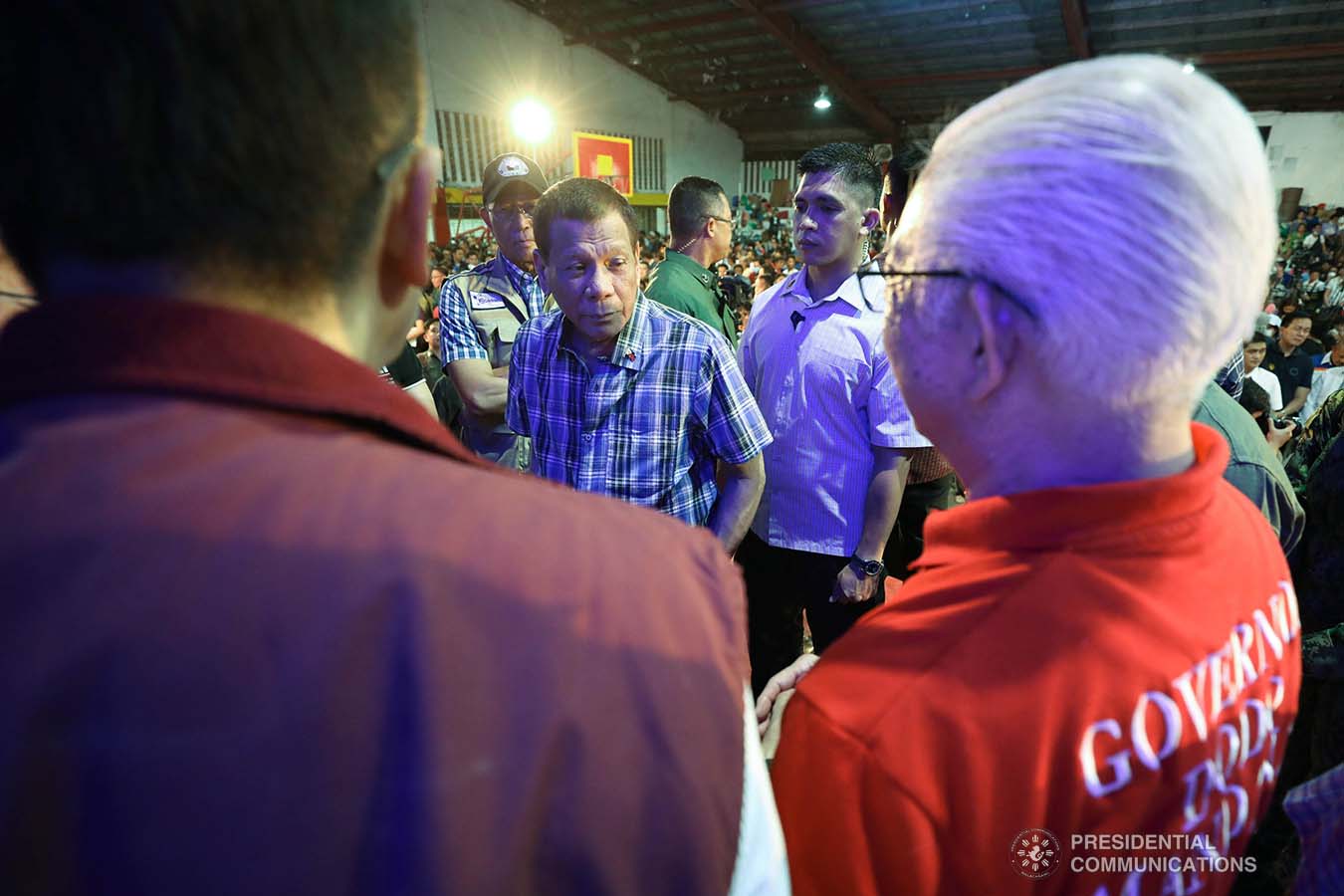 President Rodrigo Roa Duterte discusses matters with local government officials of Batangas after leading the ceremonial distribution of assistance to the families affected by the Taal Volcano eruption at the Polytechnic University of the Philippines-Sto. Tomas Campus in Sto. Tomas City, Batangas on January 20, 2020. VALERIE ESCALERA/PRESIDENTIAL PHOTO