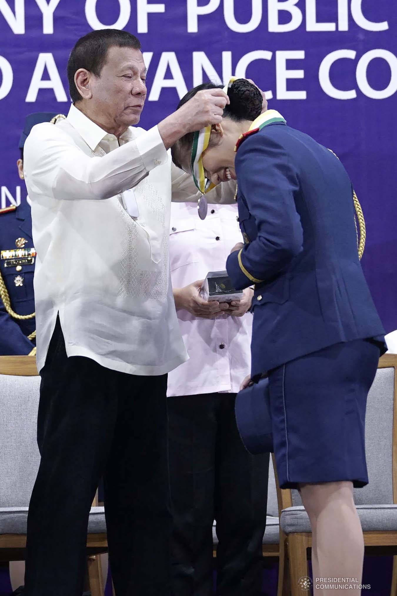President Rodrigo Roa Duterte confers a medal to one of the awardees during the joint graduation ceremony of Public Safety Officers Basic Course Class 2019-07 and Advance Course Class 2019-18 at the Arcadia Active Lifestyle Center in Davao City on February 20, 2020. ARMAN BAYLON/PRESIDENTIAL PHOTO