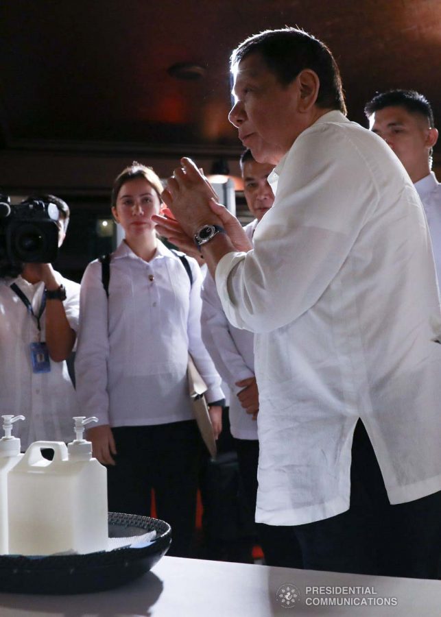 President Rodrigo Roa Duterte cleans his hands with sanitizer before heading to the Heroes Hall of Malacañan Palace to hold a briefing on the 2019 novel Coronavirus (2019-nCoV) on February 3, 2020. TOTO LOZANO/PRESIDENTIAL PHOTO