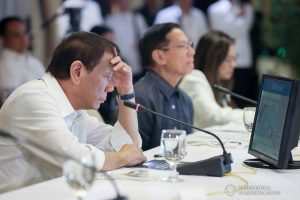 President Rodrigo Roa Duterte reads a report on the 2019 novel Coronavirus (2019-nCoV) during a briefing at the Malacañan Palace on February 3, 2020. TOTO LOZANO/PRESIDENTIAL PHOTO