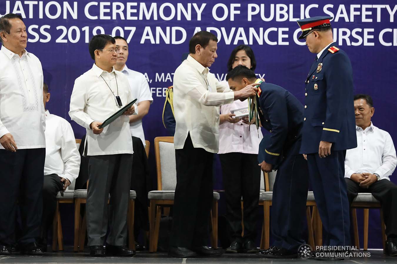 President Rodrigo Roa Duterte confers a medal to one of the awardees during the joint graduation ceremony of Public Safety Officers Basic Course Class 2019-07 and Advance Course Class 2019-18 at the Arcadia Active Lifestyle Center in Davao City on February 20, 2020. TOTO LOZANO/PRESIDENTIAL PHOTO