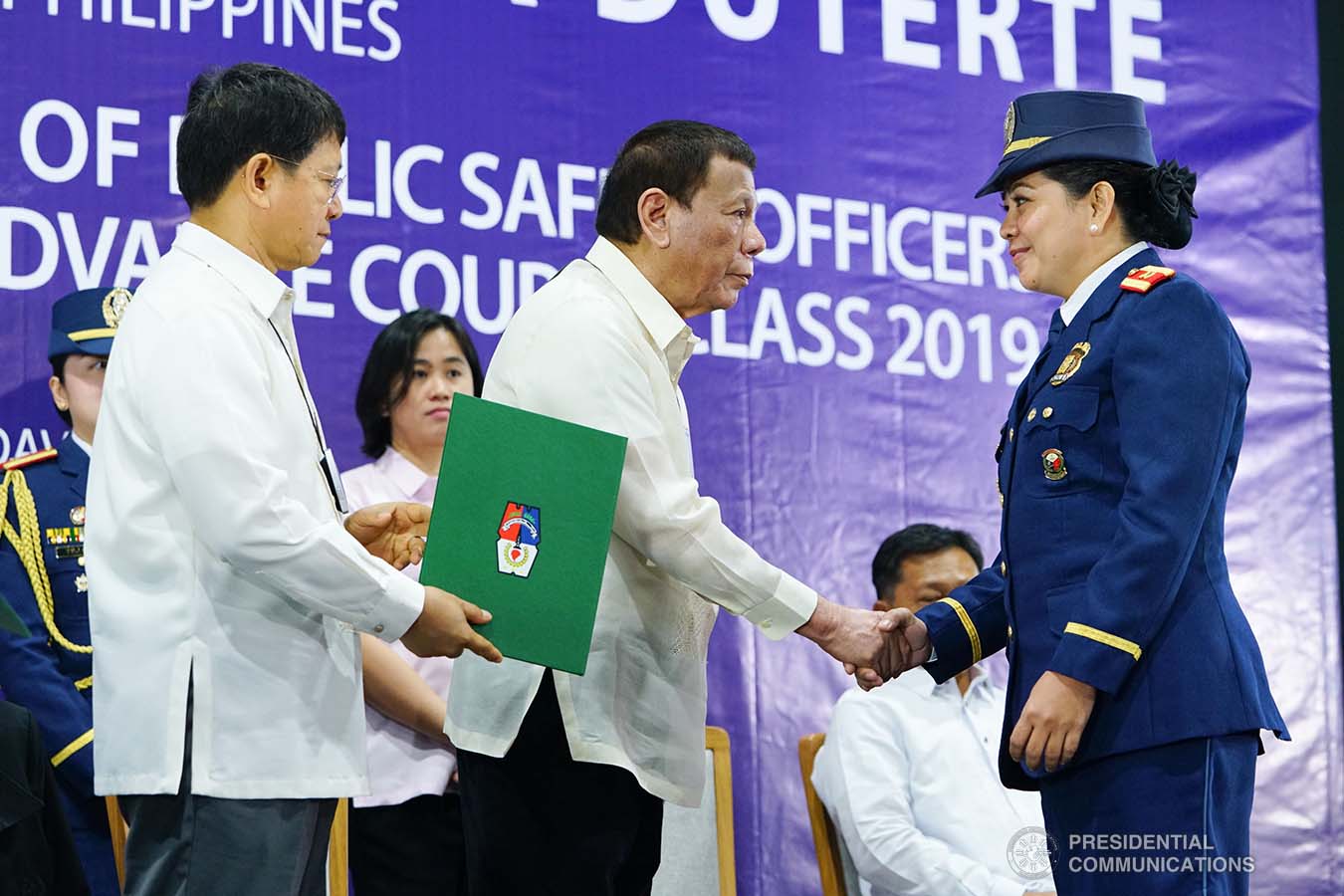 President Rodrigo Roa Duterte congratulates one of the graduates during the joint Public Safety Officers Basic Course Class 2019-07 and Advance Course Class 2019-18 graduation ceremony at the Arcadia Active Lifestyle Center in Davao City on February 20, 2020. JOEY DALUMPINES/PRESIDENTIAL PHOTO