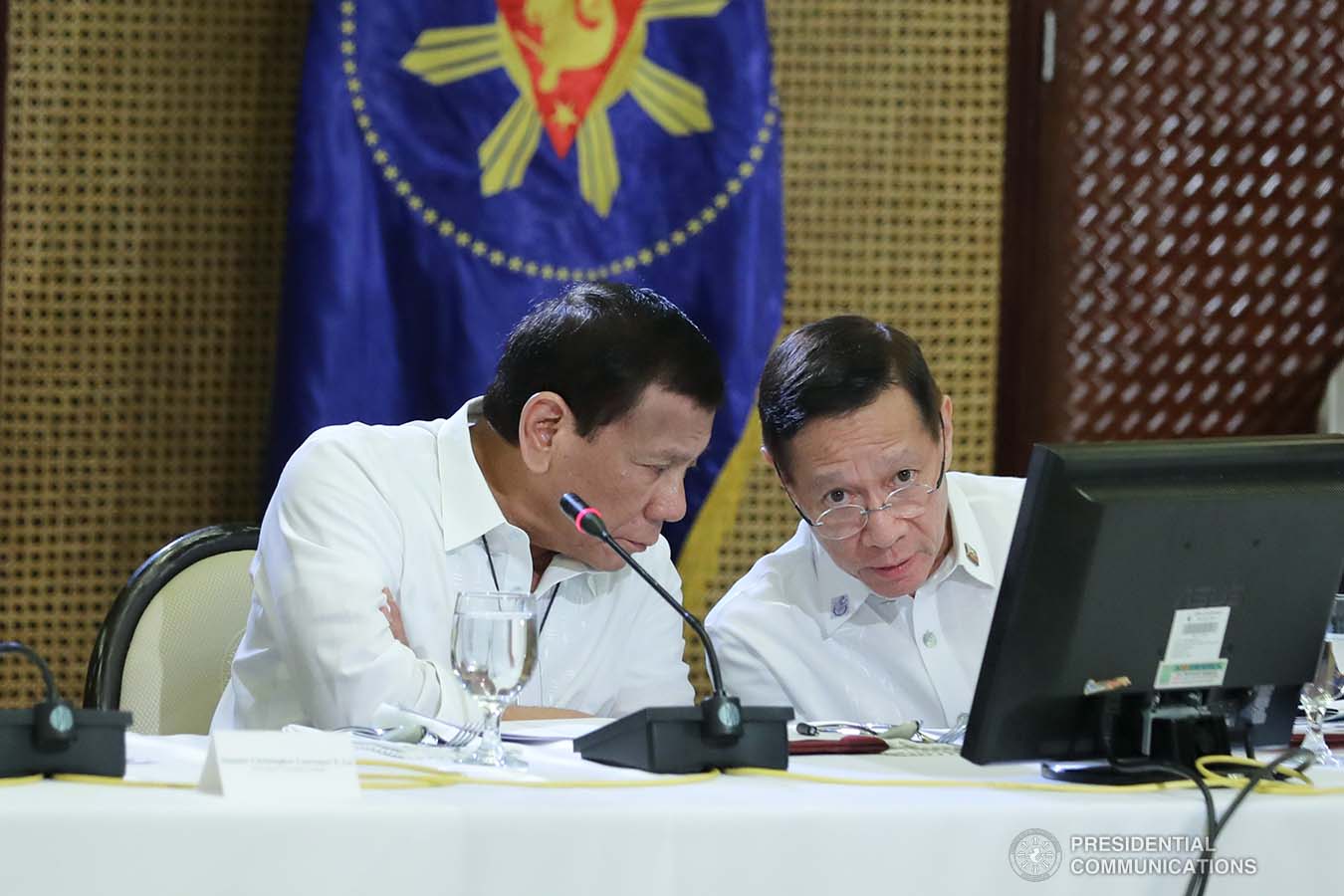 President Rodrigo Roa Duterte confers with Health Secretary Francisco Duque III during a meeting with the Inter-Agency Task Force for the Management of Emerging Infectious Diseases at the Malacañan Palace on March 9, 2020.