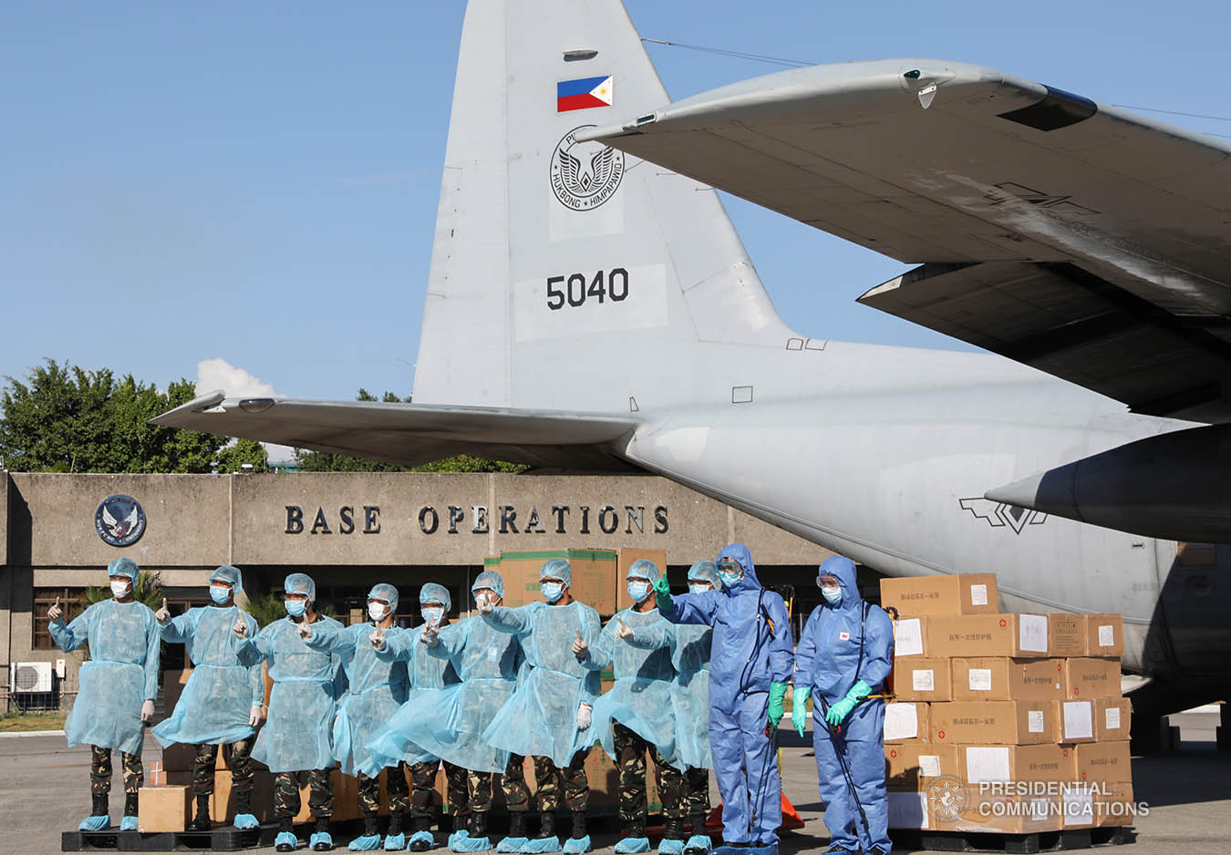Armed Forces of the Philippines personnel pose for posterity after inspecting thousands of aid packages donated by the People's Republic of China which arrived at the Villamor Air Base in Pasay City on March 21, 2020. The donation includes assorted medical supplies, personal protective equipment and testing kits for coronavirus. TOTO LOZANO/PRESIDENTIAL PHOTO