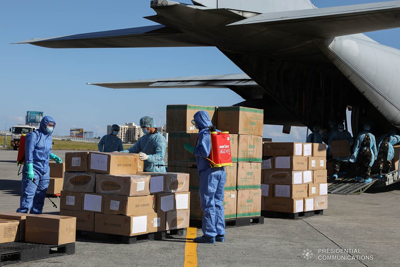 The aid packages donated by the People's Republic of China undergo disinfection upon arrival at the Villamor Air Base in Pasay City on March 21, 2020. The donation includes assorted medical supplies, personal protective equipment, and testing kits for coronavirus. TOTO LOZANO/PRESIDENTIAL PHOTO