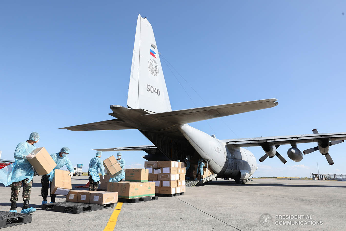 Thousands of aid packages donated by the People's Republic of China are unloaded at the Villamor Air Base in Pasay City on March 21, 2020. The donation includes assorted medical supplies, personal protective equipment, and testing kits for coronavirus. TOTO LOZANO/PRESIDENTIAL PHOTO