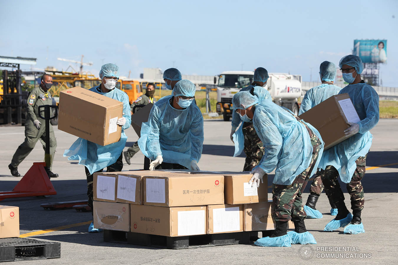 Thousands of aid packages donated by the People's Republic of China are unloaded at the Villamor Air Base in Pasay City on March 21, 2020. The donation includes assorted medical supplies, personal protective equipment, and testing kits for coronavirus. TOTO LOZANO/PRESIDENTIAL PHOTO