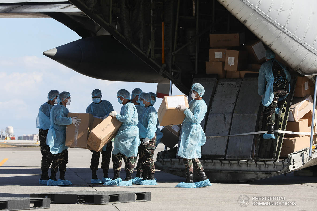 Thousands of aid packages donated by the People's Republic of China are unloaded at the Villamor Air Base in Pasay City on March 21, 2020. The donation includes assorted medical supplies, personal protective equipment, and testing kits for coronavirus. TOTO LOZANO/PRESIDENTIAL PHOTO