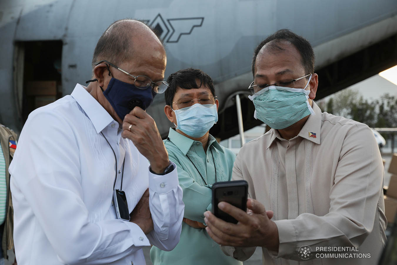 Interior and Local Government Secretary Eduardo Año, Defense Secretary Delfin Lorenzana, Presidential Adviser Carlito Galvez Jr. check the thousands of aid packages donated by the People's Republic of China to help the Philippines combat coronavirus at the Villamor Air Base in Pasay City on March 21, 2020. The donation includes assorted medical supplies, personal protective equipment, and testing kits for coronavirus. Also present was former special assistant to President Duterte and now Senate Committee on Health chairperson Senator Christopher Lawrence "Bong" Go. TOTO LOZANO/PRESIDENTIAL PHOTO