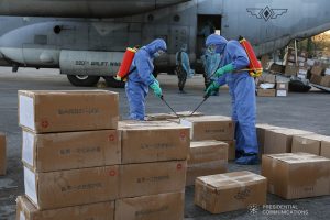 The aid packazges donated by the People's Republic of China undergo disinfection upon arrival at the Villamor Air Base in Pasay City on March 21, 2020. The donation includes assorted medical supplies, personal protective equipment, and testing kits for coronavirus. TOTO LOZANO/PRESIDENTIAL PHOTO